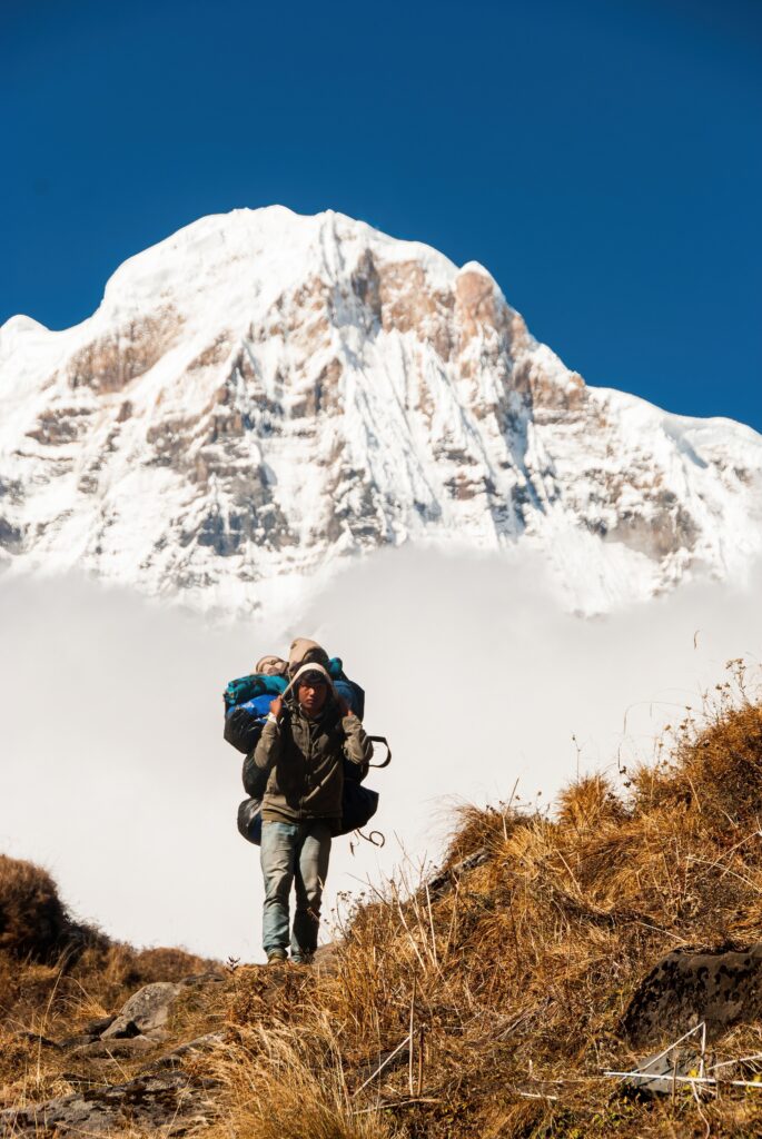 Snowy mountain background with hiker walking away